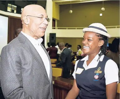  ??  ?? Governor General Sir Patrick Allen shares a light moment with Westwood High School student Sandrene McKenzie at the 2017 National Youth Consultati­ve Conference at the Jamaica Conference Centre in downtown Kingston recently.