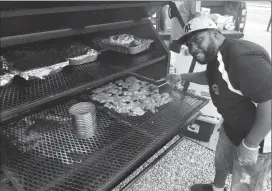  ?? Joseph B. Nadeau/The Call ?? Jermaine ‘Bugg’ Robinson mans the grill during Friday’s Metta Night Market.