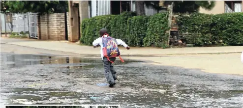  ??  ?? A boy runs through sewage spilling into a street in Boipatong.