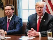  ?? Jabin Botsford/The Washington Post ?? Ron DeSantis, then-Florida governor-elect, listens as then-President Donald Trump speaks during a 2018 meeting with governors-elect at the White House.