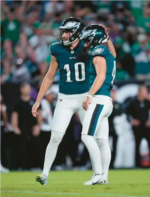  ?? MATT SLOCUM/AP ?? Not only was Arryn Siposs, left,the Eagles’ punter, but he also was the holder for kicker Jake Elliott.