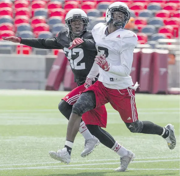  ?? — ERROL MCGIHON ?? Nick Taylor defends against wide receiver Kenny Shaw during Redblacks training camp on Wednesday.