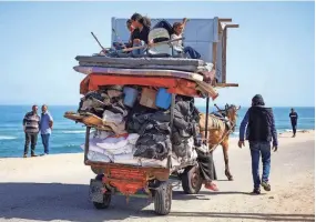  ?? MOHAMMED SALEM/REUTERS ?? Palestinia­ns flee Rafah after Israeli forces launched a ground and air operation in the eastern part of the southern Gaza city Thursday.