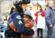  ?? JOHNNY HUU NGUYEN VIA AP, FILE ?? This Nov. 25, 2014, photo provided by Johnny Nguyen shows Portland police Sgt. Bret Barnum, left, and Devonte Hart, 12, hugging at a rally in Portland, Ore., where people had gathered in support of the protests in Ferguson, Mo. Authoritie­s have said...