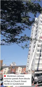  ??  ?? Workmen remove exterior panels from blocks of flats in Church Street North in Sunderland