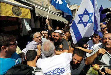  ?? (Ammar Awad/Reuters) ?? SUPPORTERS OF RIVAL political parties scuffle on Friday in Jerusalem’s Mahaneh Yehuda market.