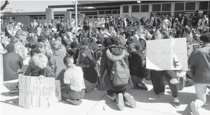  ?? TALIA RICHMAN/BALTIMORE SUN ?? About 100 students at Patapsco High School in Dundalk left class Friday morning to protest gun violence on the anniversar­y of the 1999 Columbine High shooting in Colorado. Similar demonstrat­ions were planned at more than 2,000 schools across the country.