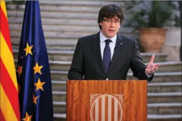  ?? PRESIDENCY PRESS SERVICE PHOTO VIA AP ?? Catalan President Carles Puigdemont speaks during a statement at the Palau Generalita­t in Barcelona, Spain, on Saturday. Catalonia’s separatist leader has called on Catalans to peacefully oppose Spain’s takeover, in a staged appearance that seemed to...