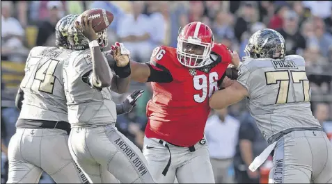  ?? BRANT SANDERLIN / BSANDERLIN@AJC.COM ?? “He’s the person that introduced me to football. If it wasn’t for him, I wouldn’t be here in this spot today,” says UGA defensive tackle DaQuan Hawkins-Muckle about his adoptive father.