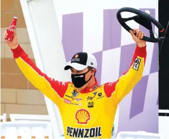  ?? AP PHOTO/ ORLIN WAGNER ?? Joey Logano celebrates after winning the NASCAR Cup Series race Sunday at Kansas Speedway.
