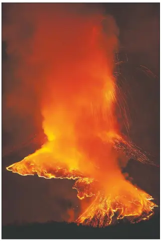  ??  ?? A fiery river of glowing lava flows on the north-east side of the Mount Etna volcano near Milo, Sicily.