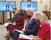  ?? — AP ?? US President Joe Biden and First Lady Jill Biden along with vice-president Kamala Harris and her husband Doug Emhoff listen to the virtual Presidenti­al Inaugural Prayer Service hosted by the Washington National Cathedral in the White House State Dining Room on Thursday.