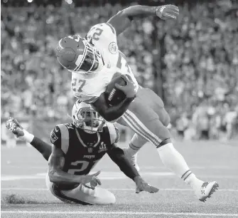  ??  ?? Chiefs running back Kareem Hunt stumbles in for a touchdown past Patriots cornerback Malcolm Butler during the first half in Foxborough, Massachuse­tts.