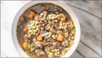  ?? CARL TREMBLAY/AMERICA’S TEST KITCHEN ?? Beef barley soup with mushrooms and thyme from the cookbook ‚”Alltime Best Soups.”