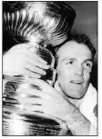  ?? (AP file photo) ?? Montreal Canadiens forward Henri Richard hugs the 1966 Stanley Cup after scoring the game-winning goal in overtime to defeat the Detroit Red Wings. Richard died Friday at the age of 84.