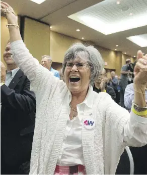  ?? DAVID BLOOM/FILES ?? A unity supporter reacts July 22 after the Wildrose party votes in favour of unity with the Progressiv­e Conservati­ves in Red Deer.