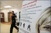  ?? IRFAN KHAN / LOS ANGELES TIMES ?? A coronaviru­s health advisory is posted in the emergency department at St. Joseph Medical Center in Orange.