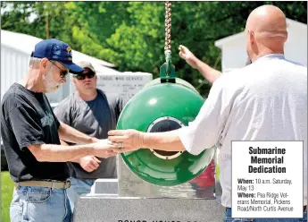  ?? TIMES photograph by Annette Beard ?? Submarine veteran Mike Rainwater, left, measures for correct placement of the Mark 37 torpedo in the memorial to submarine veterans at the Pea Ridge Veterans Memorial April 25. Rainwater was the project chief and was assisted by Bob Andregg, project...