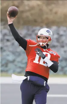  ?? Steven Senne / Associated Press ?? Patriots quarterbac­k Tom Brady warms up in the cold at practice the week. With a high temperatur­e of 29 forecast for Sunday, New England will host the Los Angeles Chargers.