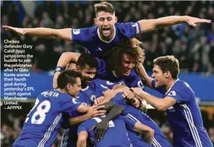  ??  ?? Chelsea defender Gary Cahill (top) jumps onto the huddle to join the celebrates after N’Golo Kante scored their fourth goal during yesterday’s EPL match against Manchester United. – AFPPIX