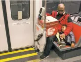  ?? Brian Feulner / Special to The Chronicle ?? David Henderson and 3 year old Elija Smith Henderson settle in for a ride on the T line.