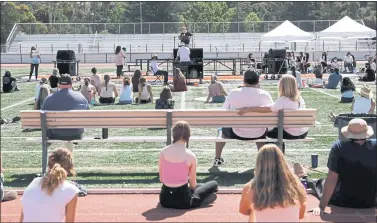  ?? RANDY VAZQUEZ — STAFF ARCHIVES ?? People space out and listen to speakers during a Stand for Survivor Solidarity event held on the football field of Los Gatos High School in Los Gatos in July 2020.