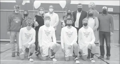  ?? Photo by Zak Lantz/The Punxsutawn­ey Spirit ?? Prior to Wednesday's game against Clearfield, the Punxsy boys basketball program honored its eldest members with a senior night ceremony. Pictured here (front row, from left) are the seniors, with their parents behind them: Nick Humble, the son of Terry and Jen Humble; Graham Lott, the son of Eric and Kelli Lott; Ethan Presloid, the son of John and Patty Presloid; and Andrew Young, the son of Tom and Shelly Young.