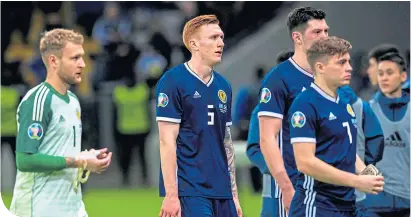  ??  ?? Scotland’s players trudge off the pitch after the humiliatio­n against Kazakhstan.