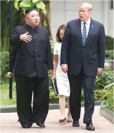  ??  ?? Kim (left) and Trump talk in the garden of the Metropole hotel during the summit. —Reuters photo