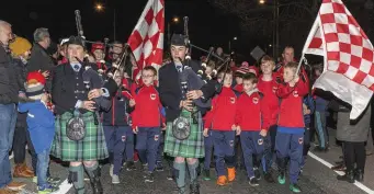  ??  ?? Pipers leading the homecoming parade in Charlevill­e last Sunday night.