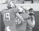  ?? NATE BILLINGS/FOR THE OKLAHOMAN ?? Oklahoma State’s Bryson Green (19), Taylor Miterko (68) and LD Brown (0) celebrate a touchdown run by Brown.