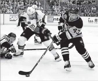  ?? [GENE J. PUSKAR/THE ASSOCIATED PRESS] ?? Conor Sheary, right, skates away from the Senators’ Erik Karlsson as Penguins teammate Jake Guentzel hits the ice in the second period.