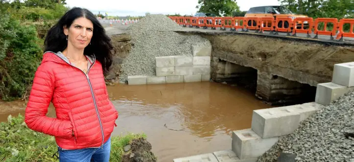  ??  ?? DEVASTATIO­N: Clockwise from main, Kathy Donaghy pictured where the bridge along the Muff to Carndonagh road collapsed last Tuesday; John McLaughlin, owner of the Point Inn Bar and B&B, which was destroyed by flood water and sewage; farmer Martin Grant...