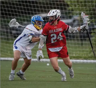  ?? AMANDA SABGA / BOSTON HERALD ?? WHERE TO GO: Reading’s Robbie Granara looks to pass while holding off Lexington’s Lorenzo Costello at Lincoln Park in Lexington on Friday night.