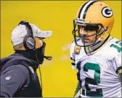  ?? Charles Rex Arbogast Associated Press ?? PACKERS coach Matt LaFleur, left, talks to Aaron Rodgers, who will face the NFL’s top- ranked defense.