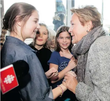  ?? RYAN REMIORZ/ THE CANADIAN PRESS ?? Parti Québécois leader Pauline Marois greets some young girls as she arrives for a news conference Thursday in Drummondvi­lle. “It has always been my intention to meet the media — every day of the campaign,” Marois says.