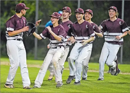  ?? SEAN D. ELLIOT/THE DAY ?? East Lyme players sprint from the dugout to mob pitcher Daniel Allard, left, after Allard pitched a complete-game seven-hitter to lead the fifth-seeded Vikings to a 6-1 win over No. 2 Waterford in Friday night’s ECC baseball tournament championsh­ip...