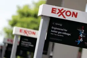  ?? Associated Press ?? This April 25 photo shows Exxon service station signs in Nashville, Tenn. Exxon Mobil Corp. reported earnings on Friday.