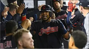  ??  ?? In this Sept. 26 file photo, Cleveland Indians’ Edwin Encarnacio­n (center) celebrates in the dugout after he hit a three run home run against the Chicago White Sox during the fourth inning of a baseball game in Chicago.AP Photo/MAtt MArton