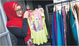  ?? Picture / Dean Purcell ?? Merissa Santoso sells Disney- themed swim sets from her online Islamic boutique store.