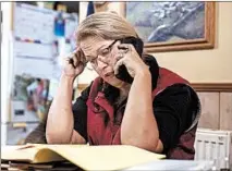  ??  ?? Anne Lee makes calls as a part of her part-time survey research job. She applied for food stamps recently to help her husband and five kids.