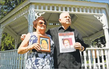  ?? Hearst Connecticu­t Media file photo ?? Dale Ocelik, left, holds a framed photograph of her big sister, Nina Coe, as Coe’s younger brother Michael Plourde displays the poster the family put up all over town when the 56yearold disappeare­d in July 2015. Plourde is hosting a candleligh­t vigil Sunday at 5 p.m. on the South Green on Main Street in Middletown.