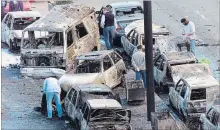  ?? ALVARO BARRIENTOS THE ASSOCIATED PRESS ?? Police comb the area where a car bomb exploded in 2001in the Basque regional capital of Vitoria, Spain.