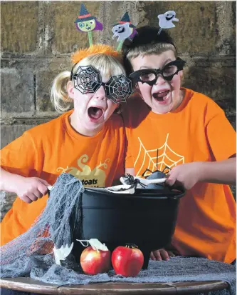  ??  ?? Olivia, five, and Tom MacDougall, seven, create a witches’ brew to launch The Stoats Creepy Crawl.