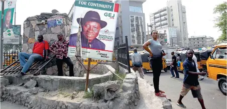  ?? PICTURE: EPA ?? CANDIDATE: President Goodluck Jonathan’s campaign poster is torn apart on a street corner in Lagos, Nigeria.