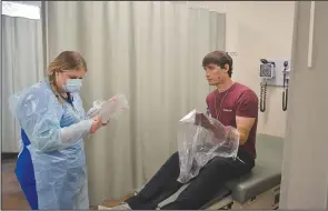  ?? (NWA Democrat-Gazette/Marc Hayot) ?? John Brown University nursing student Molly Kuykendall prepares to treat Tyler Dawson, a ‘patient,’ during the mass casualty simulation.