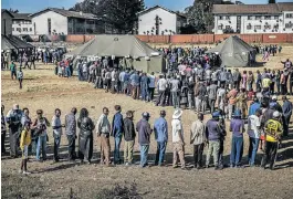  ?? /AFP (See Page 4) ?? A Bob-free election: Voters queue to cast their ballot outside a polling station in the suburb of Mbare in Zimbabwe’s capital, Harare, on Monday. It is the country’s first election since the ousting of longtime leader Robert Mugabe in November 2017.