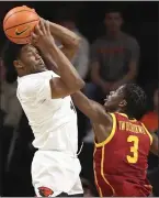  ?? AMANDA LOMAN — THE ASSOCIATED PRESS ?? Oregon State guard Dexter Akanno, left, is fouled by USC forward Vincent Iwuchukwu during the first half of Saturday’s Pac-12 game in Corvallis.