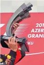  ??  ?? Winner: Daniel Ricciardo shows off the trophy after his victory in Baku