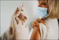  ?? GETTY IMAGES ?? Female doctor giving a vaccine of mature woman at home. Shot of general practition­er giving injection to senior woman at home. Female senior patient getting vaccinated during covid-19 pandemic. Coronaviru­s vaccinatio­n concept.